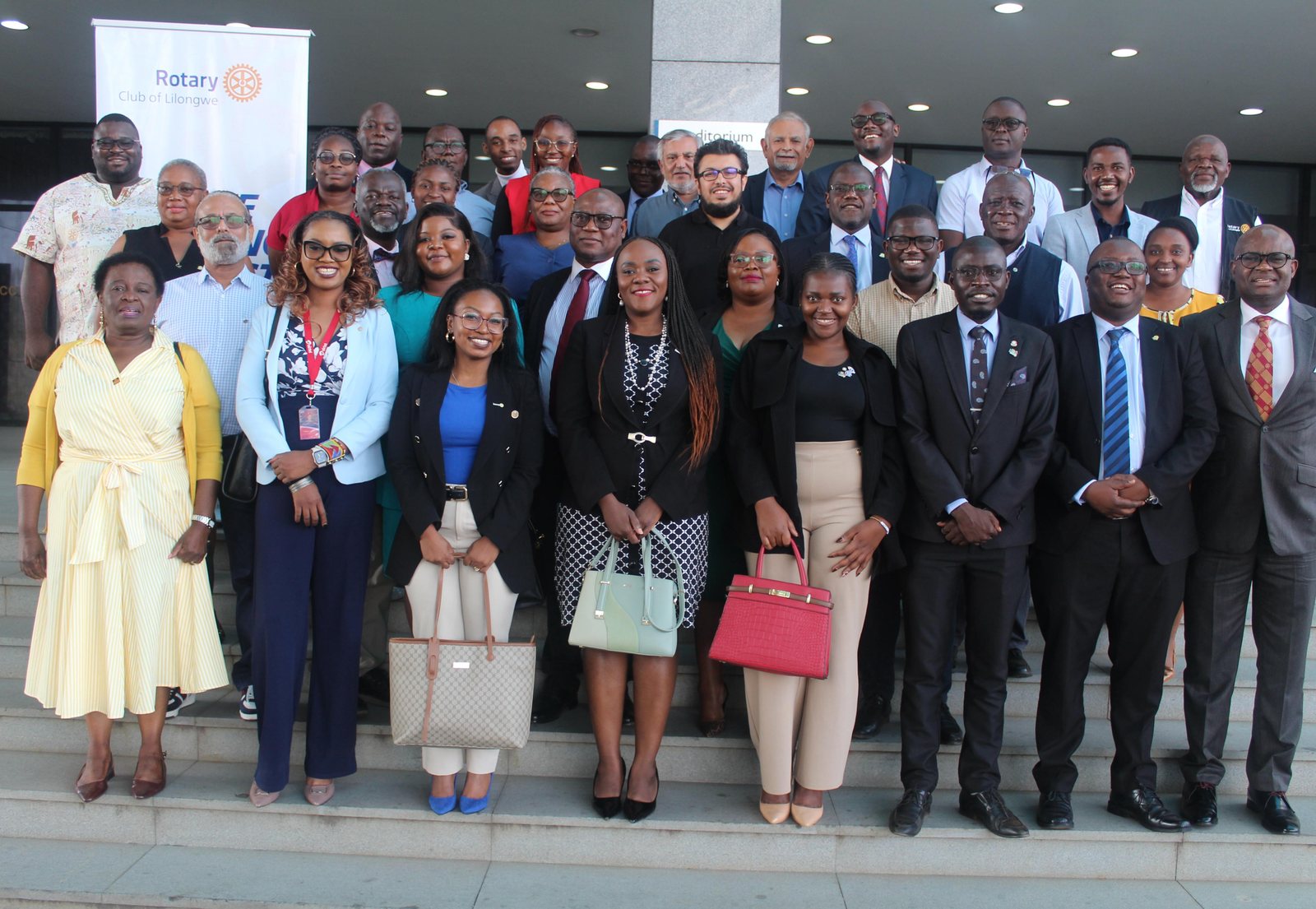 Members of the Rotary Club of Lilongwe gathered on the steps of the Bingu International Convention Centre